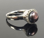 ANEL EM OURO BRANCO COM CRAVAÇÃO DE DIAMANTES E  PÉROLA NEGRA BARROCA CENTRAL.. ARO 26.  5,7 G. (ATENÇÃO OS LOTES DE JÓIAS NÃO PERTENCEM AO ACERVO SÃO DE OUTRO COMITENTE  E POR ESSE MOTIVO NÃO SERÃO DEMONSTRADOS NA EXPOSIÇÃO DA FAZENDA SANTA GERTRUDES INFORMAÇÕES COM O ESCRITÓRIO DA DARGENT)