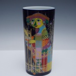 ROSENTHAL  MIL E UMA NOITES POR BJORN WIINBLAD  SERIE SCHEHERAZADE -  VASO ALTO E CILÍNDRICO DE PORCELANA, DESENHADO PELO ARTISTA DINAMARQUÊS BJORN WIINBLAD PARA A ROSENTHAL STUDIO-LINIE, ALEMANHA. ESTA PEÇA PERTENCE À SÉRIE 1001 NACHT (MIL E UMA NOITES), QUE EXIBE O ESTILO LÚDICO CARACTERÍSTICO DE WIINBLAD, COM CORES VIBRANTES E DETALHES INTRINCADOS EM OURO. O DESIGN APRESENTA UMA FIGURA FEMININA ESTILIZADA, INSPIRADA EM CONTOS DAS MIL E UMA NOITES , RODEADA POR UMA ORNAMENTADA TRELIÇA DOURADA E MOTIVOS FLORAIS. MARCADO NA BASE COM A MARCA ORIGINAL DA STUDIO-LINIE , ROSENTHAL E A ASSINATURA  DE WIINBLAD. 28 CM DE ALTURANOTA: A série Rosenthal Mil e Uma Noites (originalmente 1001 Nacht) é uma das coleções mais icônicas da porcelana alemã Rosenthal Studio-Linie, criada pelo renomado artista dinamarquês Bjrn Wiinblad (19182006). Lançada por volta de 1969, a série é famosa por seu estilo lúdico e detalhes intrincados que dão vida aos contos de fadas orientais.  Scheherazade: é uma  sub-série focada em peças decorativas de luxo, como vasos e pratos com acabamento espelhado em ouro e detalhes em cores como vermelho e verde. 