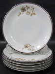 RENNER, Medaillon, Seis pratos de sobremesa em porcelana esmaltada na tonalidade branca com pintura de flores e folhagens em policromia, borda filetada a prata. Med.: 17,5cm.