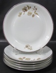 RENNER, Medaillon, Seis pratos rasos em porcelana esmaltada na tonalidade branca com pintura de flores e folhagens em policromia, borda filetada a prata. Med.: 25cm.