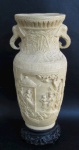 DIVERSOS, Vaso/ânfora em resina, decorado com figuras em relevo, alças laterais representando elefantes, apresenta bicados. Med.: 30x10cm.