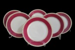 PRINCESS, China, Seis pratos para sobremesa em porcelana esmaltada na tonalidade creme, decorado com espessa faixa na tonalidade vinho, borda torcida filetada a ouro. Med.: 20cm.