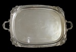 METAL PRATEADO, Bandeja retangular em metal espessurado a prata, ricamente cinzelada por elementos vegetalistas, borda com flores e folhagens em relevo. Med.: 64x40cm.