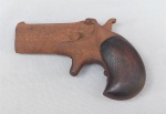 MILITARIA, uma (1) pequena e antiga garrucha de dois canos, usada por jogadores de poker ou carregadas no espartilho por mulheres, confeccionada em aço, sinais de oxidação, coronha com detalhes em madeira, inutilizada para disparo, medindo 12 cm comprimento, observação: este item não pode ser enviado via Correios.