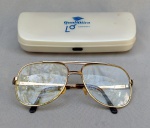 DIVERSOS, um (1) óculos marcado Marcolin Italy - armação metálica modelo esporte fino aviador, com lentes de grau bifocais, acompanha case adaptada; usado com desgaste.