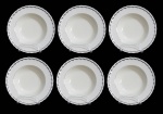 GRINDLEY, Inglaterra, Seis pratos fundos em faiança vitrificada, borda ondulada, espessa faixa em prata. 1 bicado. Med.: 23cm.