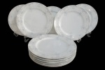 IMPERIAL CHINA, Onze pratos rasos em porcelana esmaltada na tonalidade branca com pintura de flores, arabescos e folhagens na tonalidade azul. 1 bicado. Med.: 26cm.