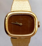 RELÓGIO, um (1) de pulso da marca TIMEX, caixa e pulseira em metal dourado, mecânico a corda, parado, medindo 25 x 20 mm, usado e sem garantia.