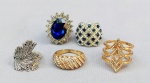 BIJUTERIAS, lote com cinco (05) anéis diversos, de diferentes modelos, confeccionados em metal dourado e prateado com pedraria; medidas aro 18/19 aproximadamente. Vide foto.