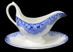 FAIANÇA, Molheira e presentoir em faiança vitrificada na tonalidade branca, com pintura de flores e folhagens na cor azul, marcada, porém com falhas. Med.: 17x21x9cm / 24x15cm.