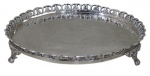METAL PRATEADO, Salva em metal espessurado a prata, fundo cinzelado por folhagens e galeria vazada, apoiada sobre 3 pés em garra. Banho novo. Med.: 17,5cm.