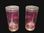 CRISTAIS, Dois copos para água/whisky em cristal na tonalidade rosa, lapidado por barco a vela, coqueiro e esferas ao gosto Fratelli Vita, borda e base filetada a ouro, apresenta falhas na douração. Med.: 14x7cm.
