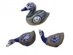 ESCULTURAS, Três esculturas em faiança vitrificada, com realces na tonalidade azul, guarnecido em metal dourado, representando patos, fabricados no México. Medida: 13x16x8cm / 7,5x12x6,5cm. 1 com pescoço colado.