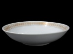 SCHMIDT, Saladeira em porcelana esmaltada na tonalidade branca, com pintura de flores e folhagens em espessa faixa em vasta douração, apresenta falhas na douração. Med.: 25cm.