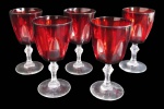 FRANCE, Cinco taças para vinho em vidro na tonalidade vermelha, haste facetada translucida apoiada sobre base circular. Med.: 13x6,5cm.