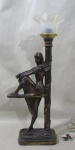 ABAJUR, confeccionado em resina, estilo art noveau, revestida em metal dourado, representando figura feminina sentada, flores e folhagens em relevo, cúpula em plástico rígido, fiação no estado. Med.: 60x24x13cm.