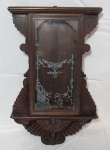 RELÓGIOS, Caixa para relógio de parede, confeccionada em madeira, parte inferior recortada, frente com porta articulada envidraçada, vidro jateado com falhas na pintura, falta acabamento superior. Medidas: 57x33x10cm.
