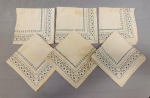 CAMA E MESA, lote com seis (6) guardanapos em tecido de algodão misto, na tonalidade bege, com estampa floral em azul, medindo aproximadamente 39x37; usado, com manchas.