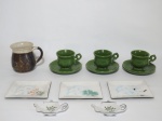 Nove itens, sendo: 3 petisqueiras em cloisonné esmalte, manufatura japonesa TUTANKA, medindo 12 cm x 10 cm; 3 xícaras de cerâmica com pires na cor verde; 2 porta-chá em porcelana decorada com folhagens nos tons de verde, contorno em prata e 1 caneca para café medindo 10 cm de altura.