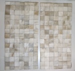 Par de tapetes em couro de boi, costurado em quadrados. 141 x 69cm.