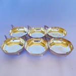 EBERLE - Lote com 6 (seis) taças para sobremesa em formato octogonal com pegador e pés em bola em metal espessurado a prata. Med.: 9cm de diâmetro. Apresenta desgastes.