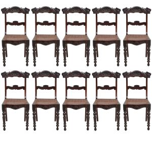 <b>Conjunto de 10 cadeiras pernambucanas</b>, ditas Beranger, construídas em madeira de lei. Espaldar vazado e decorado com entalhes floridos assim como a parte anterior da saia. Pernas anteriores em segmentos torneados e assento em palhinha. Acompanha almofadas em tecido cotelê na cor telha. Séc. XIX. Alt. 90,5 cm