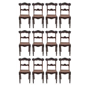 <b>Conjunto de 12 cadeiras</b>, sendo duas de braços, pernambucanas, Beranger, construídas em madeira de lei. Espaldar vazado decorado com flores e folhas assim como a parte anterior da saia. Pernas anteriores em segmentos torneados e assento em palhinha. Acompanha almofadas em tecido cotelê na cor telha e as de braço almofadas listradas. Séc. XIX. Alt. 87,5 cm