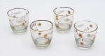 Quatro copinhos para drink  com  pinturas, com borda dourada. Altura: 7 cm.