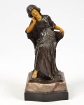 Estatueta em pewter e baquelite, reproduzindo imagem de dama sentada, base em dois tipos de mármore, sem assinatura, altura total 23 x 10,5 x 12 cm, altura da base 4 cm.