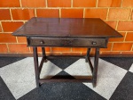MOBILIÁRIO - mesa cavalete de encostar em madeira nobre com uma gaveta central. Med. 80x112x79 cm. Marcas do tempo e de uso.
