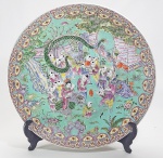 CHINA, DINASTIA QING, SÉC.XIX/XX - Grande medalhão em porcelana chinesa pintado a mão, decorado com o tema "Boys Playing with Dragons", em rica policromia e detalhes minuciosos. Esmaltes da Familia Rosa sobre fundo azul turquesa. Verso decorado com pinturas de aves e flores. Sem marca. Med. 45 cm.