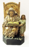 Sant'Anna mestre - arte sacra  em escultura em rica policromia e patinada sobre uma base retangular. Peça em estuque medindo 37 cm de altura e base de 22 x 12 cm.