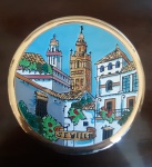 Prato decorativo em louça, com desenho em relevo, pintado à mão com acabamento na cor ouro e bela policromia, representando a cidade de Sevilla - Diâmetro: 17 cm