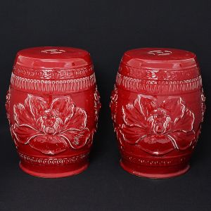 <b>Par de "garden seats" </b>em forma de tamboretes, em porcelana chinesa, cobertos por esmalte monocromático sangue de boi. Decoração com flores e máscaras de animais. Alças laterais embutidas. Alt. 45 cm