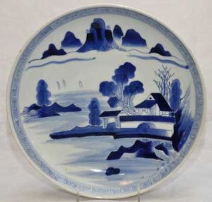 <b>Medalhão </b>em porcelana chinesa decorada em azul cobalto com cena lacustre. Séc. XIX. Diâm. 30,5 cm