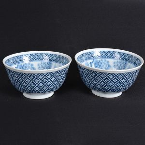 <b>Par de pequenos "bowls" </b>em porcelana japonesa azul e branco decorada com arabescos e flores. Marca no verso. Alt. 6 cm; Diâm. 13 cm