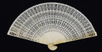 Leque com pás de acabamento em marfim e corpo em material sintético. Aberto: 36 cm. Fechado: 20 cm de altura. Apresenta perda mínima em duas aletas.