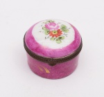 Caixinha redonda, porta comprimidos, em porcelana francesa Limoges na cor rosa com flores no tampo. Diâmetro:  4 cm. Altura: 3,5 cm.