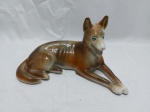 Linda escultura na forma de cachorro deitado em porcelana Mauá Trenzinho. Medindo 23,5cm x 13,5cm de altura. Com restauro.