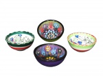 FAIANÇA, quatro bowls confeccionados em faiança vitrificada branca europeia, sendo a) Dois decorados com pinturas em alto relevo com motivos abstratos em rica policromia, medindo 4 x 8 cm. b) Dois decorados com motivos florais em policromia, medindo 3,5 x 8 cm. Dois possuem bicados na borda e possui leve bicado no fundo.