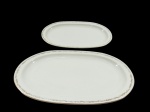 PORCELANA KPM GERMANY, par de travessas ovaladas confeccionadas em porcelana vitrificada branca europeia da coleção Royal Ivory, bordas decoradas com delicados ramos de flores em douração. Marcadas no fundo. Medidas 38 x 25 cm