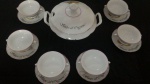 Belo conjunto em porcelana na cor branca para creme de cebola, com a inscrição em francês " Soupe à l'oignon". Composto de 1 sopeira e 6 recipientes com sousplat.
