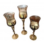 Terno de castiçais em com bojo de cristal na cor pêssego e jateado em dourado, haste retoricada e base metalizada em dourado, Alt. 45, 40 e 35, Diam. 12 cm.