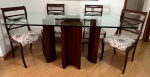 Conjunto de mesa de jantar com tampo retangular com tampo em cristal, base estilo art deco torneada - med. 80x170x90 cm (base com falhas na folha da madeira) acompanha seis cadeiras estilo inglês em madeira nobre torneada e vazada, assentos estofados em tecido floral - med. 93x47x45 cm (algumas pernas com pequenos desgastes no verniz) - este lote não se encontra no local do leilão, tendo que ser agendada a retirada no Bairro da Tijuca