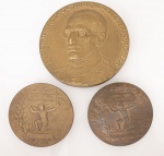 Colecionismo - Lote constando de três medalhas em bronze, sendo uma da "visita do Cardeal Eugenio Pacelli" ao Brasil med. 7 cm de diâmetro, duas da "Associação protectora dos invalidos Diamantina - 1899" - "Ajudai-vos uns aos outros" med. 5 cm de diâmetro, peso total aproximado 273 gr.