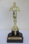 COLECIONISMO - Maravilhoso TROFÉU - Lembra o OSCAR, com as inscrições em inglês WORLD`S GREATEST GRANDPA - (O MAIOR VOVÔ DO MUNDO). Com a base mede aprox. 20,5 cm de altura. Item vendido na Walt Disney World.