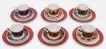 CONJUNTO DE PORCELANA composto de 5 xícaras para chá em porcelana, com seus 6pires e 6 pratos para bolo. Apresenta decoração policromada em esmaltes marmorizados, distribuída em triângulos bordados porfiletes dourados. Margens dos pratos repetindo os marmorizados vermelhos. Marcas da manufatura nas bases. Med. Alt. 7,0 cm e Diâm. 8,0 cm (Xícaras), Diâm. 14,0 cm (Pires) e Diâm. 20,0 cm (Prato de bôlo).