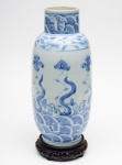VASO em porcelana oriental azul e branco, formato bojudo e gargalo curto. Decoração com flores e folhas. Sem marca na base. Acompanha pedestal em madeira ebanizada.. OBS: Pequeno bicado na base.Med Alt. 35,5 cm  Larg. 15,0 cm