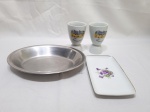 Lote de travessa oval em aço inox com par de porta ovos e petisqueira em porcelana. Medindo a travessa 23cm x 17cm x 3cm de altura.