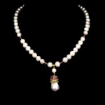 Majestoso colar de Pérolas, design exclusivo de excepcional ourivesaria, fino acabamento com botões de turmalina e belíssimo pingente em prata espessurada a ouro amarelo adornado por rico trabalho no formato de Coroa com rica cravação de Rubis de lapidação oval brilhante e linda Pérola barroca de 18 mm. Perfeito estado de conservação , sem uso. Mede aprox 46 cm , pingente 4,5 x 1,5 cm. Origem África e Tailândia .